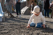 © phpetrunina14 - Toddler playing on gravel playground in sunny park Portrait