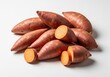 © retirementfun - A group of raw, uncooked sweet potato tubers, featuring their rich, reddish-brown skin and firm texture, ideal for healthy cooking and baking recipes, preparation, vegetable, reddish