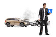 © Ljupco Smokovski - Learner driver in a torn suit standing by a car crash holding a steering wheel and an l-plate