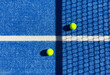 © Angelov - paddle tennis ball near the net on a blue paddle tennis court