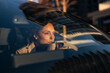 © Jelena - Woman driving car contemplating sunset during evening commute