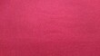© Putu - ​Red fabric texture background, bright pink magenta textile surface closeup.