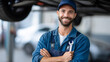 © Olha Havelia - a mechanic in blue overalls, holding a wrench and standing under a car on a white background, full-body portrait, real photograph