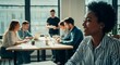 © Benjamin - A diverse group of young professionals engaged in a meeting at a modern office table by the window.