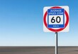 © DIAN - Speed Limit Sign Depicting 60 Km/h in an Average Speed Zone with Clear Sky Background
