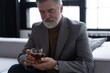 © opolja - Confident mature businessman chilling relaxing drinking enjoying whiskey after work.