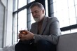 © opolja - Confident mature businessman chilling relaxing drinking enjoying whiskey after work.