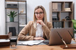 © New Africa - Portrait of notary at wooden desk in office