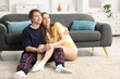 © New Africa - Happy couple in pajamas spending day together on floor at home