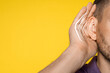 © New Africa - Hearing health. Man with audio waves coming to his ear on yellow background, closeup
