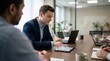© TechVision Studio - Focused businessman in navy suit using tablet at wooden conference table with laptops and coffee cups, modern office meeting, collaborative discussion, team, business strategy, corporate
