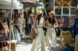 © apichat - Asian women shopping at outdoor market during summer vacation