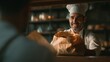 © slamet - Chef handing over a paper bag bakery service food delivery concept