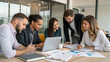 © Anatoli - Group works together in an office space on a project while discussing ideas and strategies during daytime hours