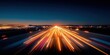 © NovaVision - Highway at night with light trails from moving cars creating a sense of speed and motion