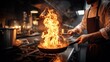 © NovaVision - Chef flambeing food in a pan with intense flames in a professional kitchen setting