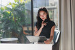 © crizzystudio - Young asian woman thinking while reviewing documents