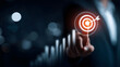 © estrel - A modern business concept image showing a businessman touching a digital target with an arrow hitting the center symbolizing goal achievement growth strategy and su