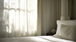© Big - Hotel bed with crisp white linens and decorative pillow in soft morning light through sheer curtains.