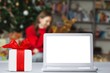 © BillionPhotos.com - Happy girl with laptop in a Christmas decoration background