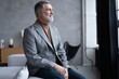 © opolja - Portrait of a confident mature businessman near the window.