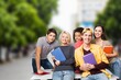 © BillionPhotos.com - Smiling teenagers school students friends outside
