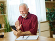 © Lumos sp - Portrait of a senior mature man or businessman working from home office using smart phone and having a video call meeting  at home
