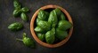 © AkuAku - Birds eye perspective of fresh organic basil leaves set in a handcrafted wooden bowl emphasizing natural freshness