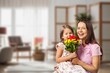 © BillionPhotos.com - Cute happy Child congratulating mom giving flowers.