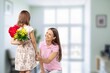© BillionPhotos.com - Cute happy Child congratulating mom giving flowers.