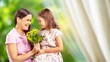 © BillionPhotos.com - Happy women's day. Child congratulating mom with flowers.