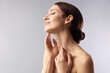 © New Africa - Beautiful woman touching her neck on light grey background. Space for text