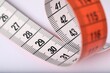 © New Africa - One measuring tape on white background, closeup
