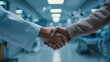 © Cleverson - A doctor and patient shake hands in a hospital room with medical equipment