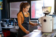© apichat - Barista preparing coffee drink using espresso machine
