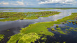 © Gino Tuesta - Panoramic aerial drone view of the riverfront boulevard of Iquitos along the Río Amazonas in the Peruvian Amazon, tropical waterfront surrounded by rainforest, popular destination for travel