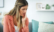 © peopleimages.com - Toothache, upset or woman with pain on couch, gum inflammation or dental problem for mouth discomfort. Tooth sensitivity, swollen cavity or person in home with oral infection, sore or enamel decay