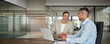 © insta_photos - Happy professional business team people of two smiling latin executive business men having conversation on digital financial investment technology management using laptop computer working in office.