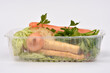 © nahhan - A variety of fresh soup vegetables including carrots, parsley, onion and parsnip packed in a transparent plastic container on a white background