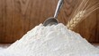 © Robiul - Heap of pure white wheat flour with metal scoop and wheat ears on wooden background