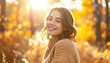 © mili - Woman with a warm smile amidst golden foliage, sunlit in an autumn scene wearing a tan sweater