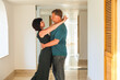 © ALEXEY - Romantic embrace of a loving adult couple in a hotel corridor, capturing the essence of intimacy and connection in a cozy, elegant setting.