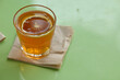 © antonihalim - Refreshing glass of orange tea on a napkin
