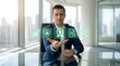 © Tharindu - Businessman at Desk Using Emerald Green Holographic Business Icons