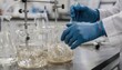 © DigitalSpace - Close view of researchers blending highviscosity polymer mixtures in glass vessels demonstrating precise manual techniques in solution polymerization lab work.