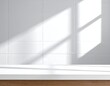 © Mazor - A stark, minimalist composition featuring white tiled wall and surface, bathed in sunlight from a window, creating shadow play