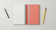 © sevika - Open spiral notebook with pink cover and writing tools.