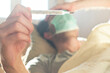 © Teodor Lazarev - Hand holding thermometer checking patient fever in bed