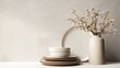 © Luminary Studio - Arrangement of Ceramic Plates and Bowls With Dried Flowers in a Vase