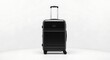 © Agung - Black suitcase standing on wheels in a white studio environment